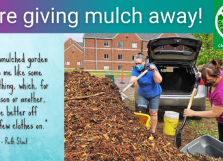 photo of two women shovelling mulch