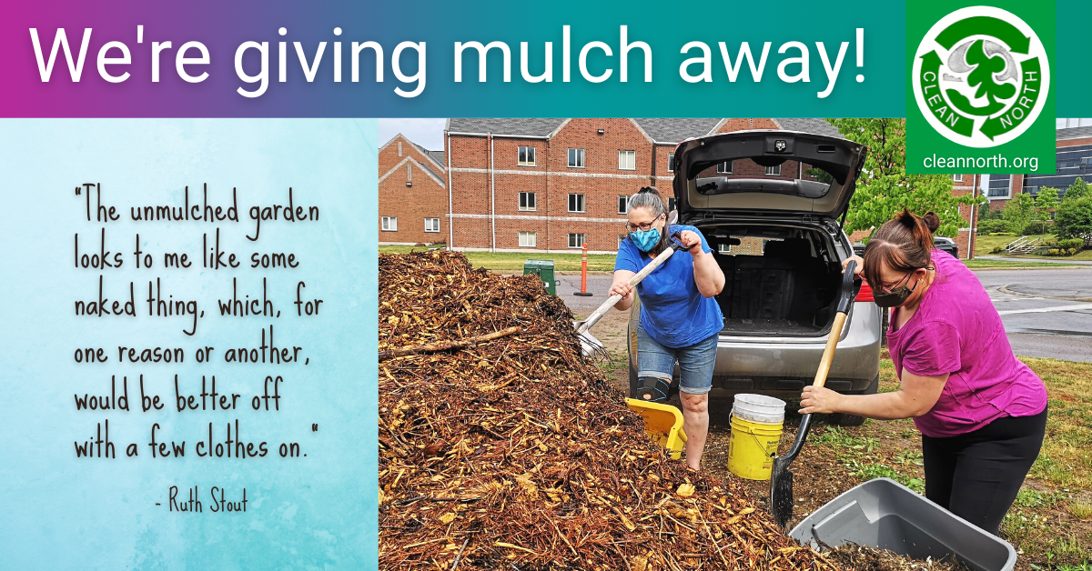 photo of two women shovelling mulch