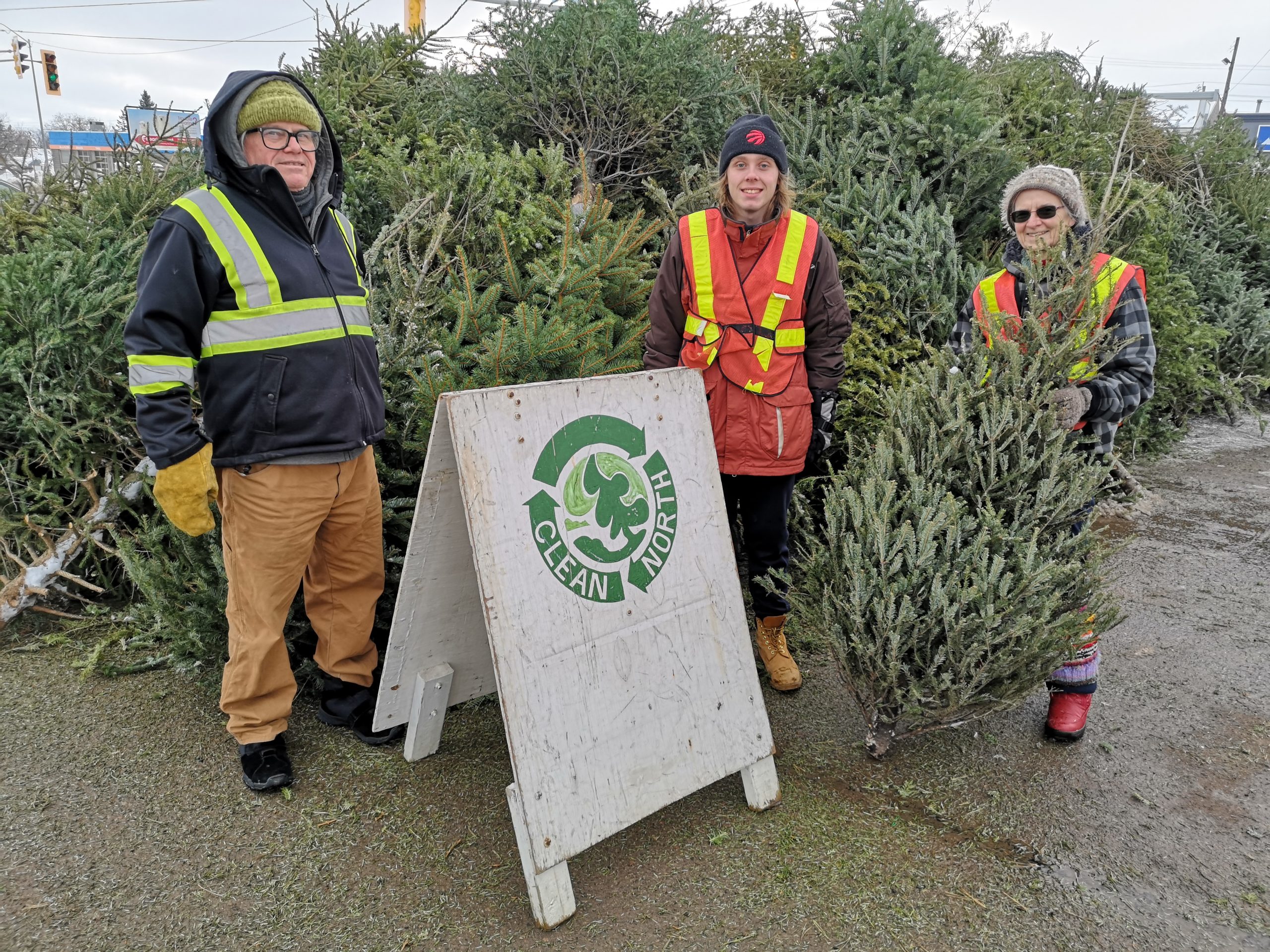 photo of three volunteers at Christmas tree collection depot
